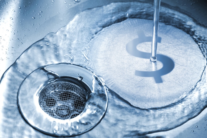 water in sink with money sign