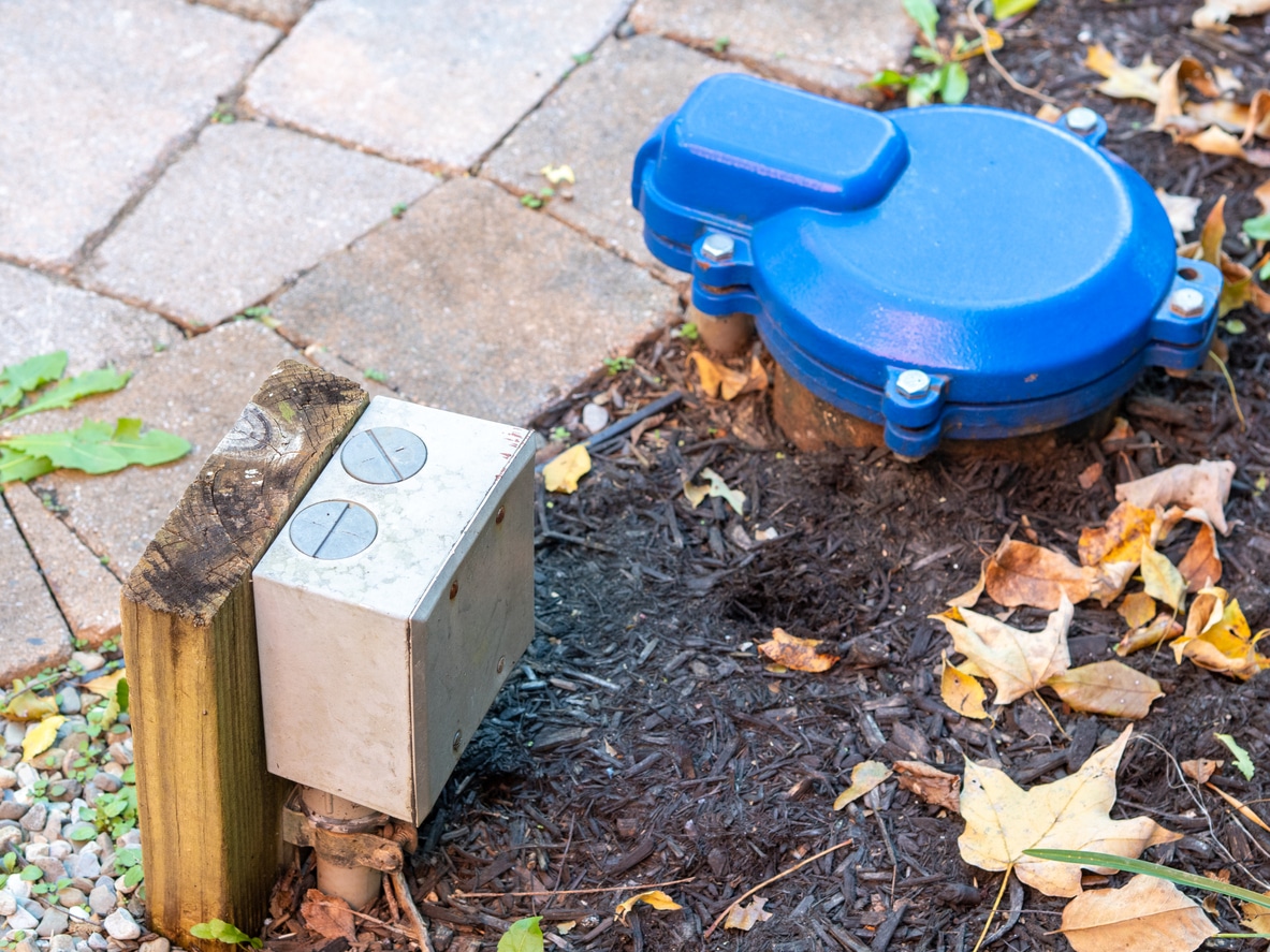 outside feature of a well pump with blue cover and electric outlet