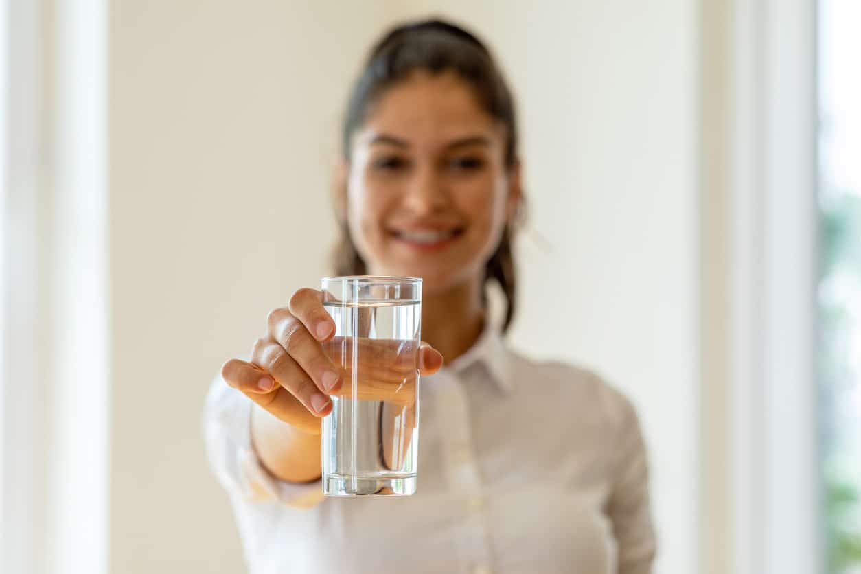 Young girl holding glass of water