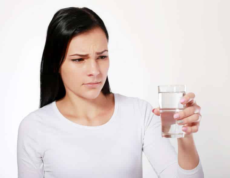 woman looking at water looking unhappy