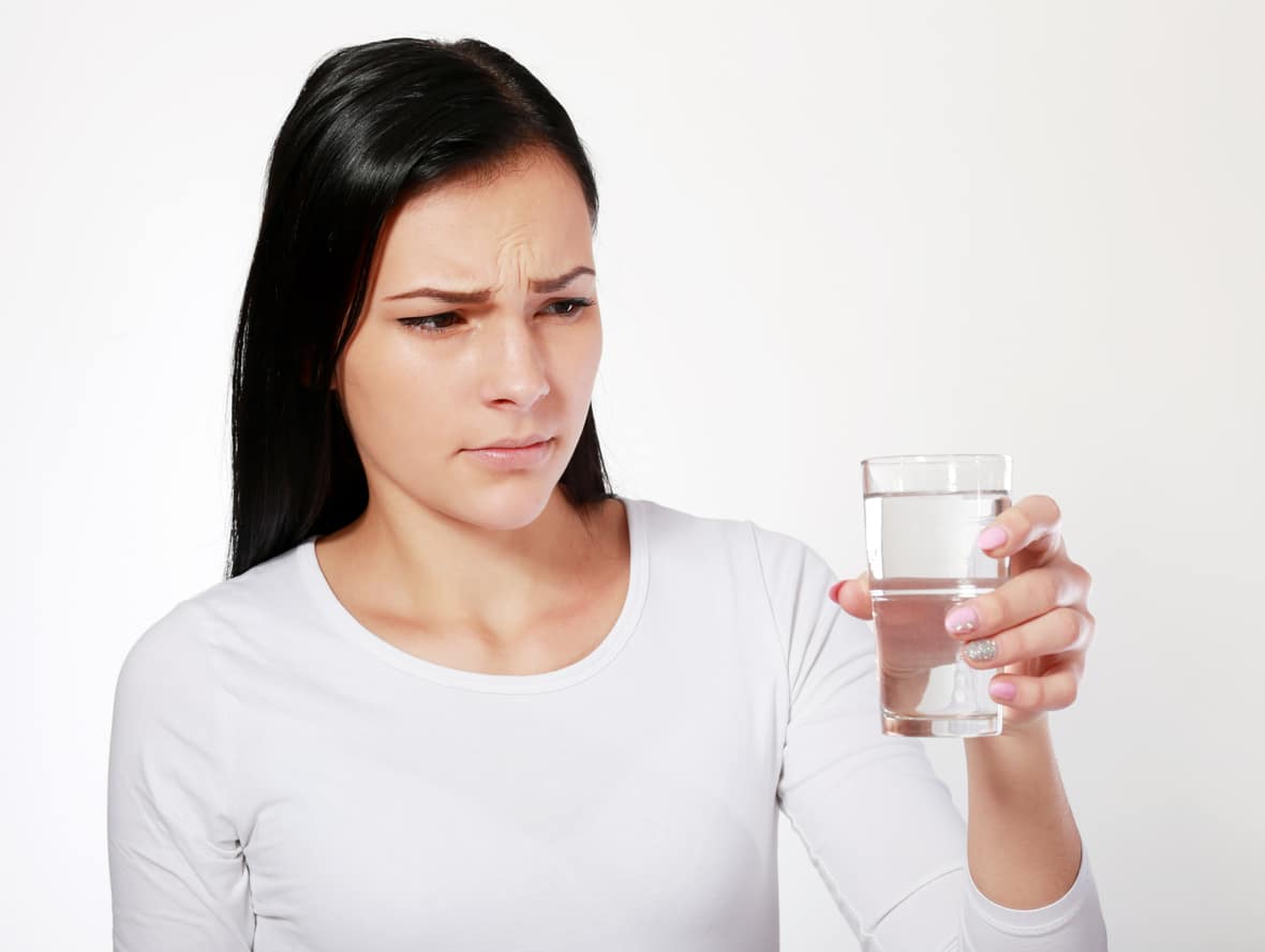 woman looking at water looking unhappy